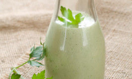 Greeen dressing made with yogurt or sour cream, selective focus